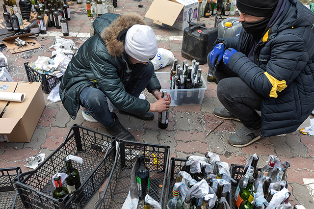 Civilians in Kiev making  Molotov bombs